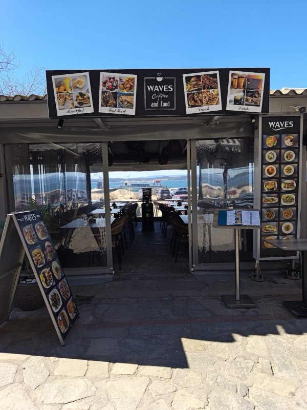 The Waves Coffee & Food terrace, with the sea framed through the entrance