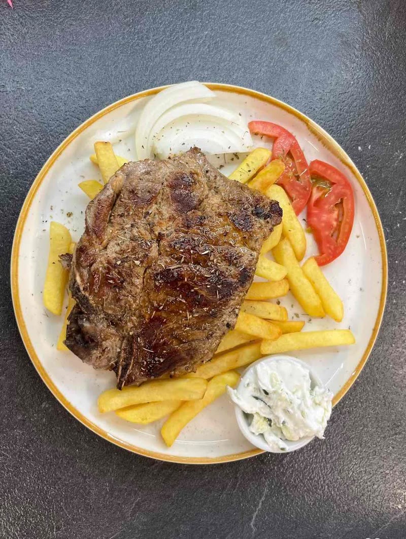 Grilled steak with fries and tzatziki